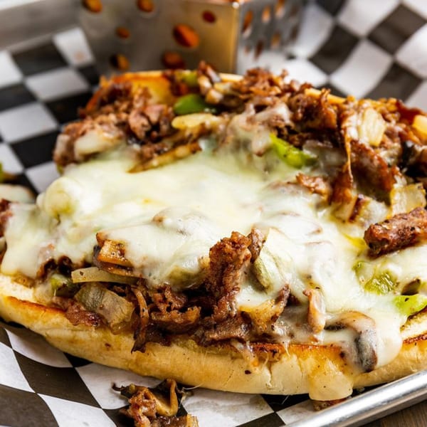 Cheesesteak sandwich from Rookies Sports Bar & Grill, with melted cheese, steak, onions, and peppers.
